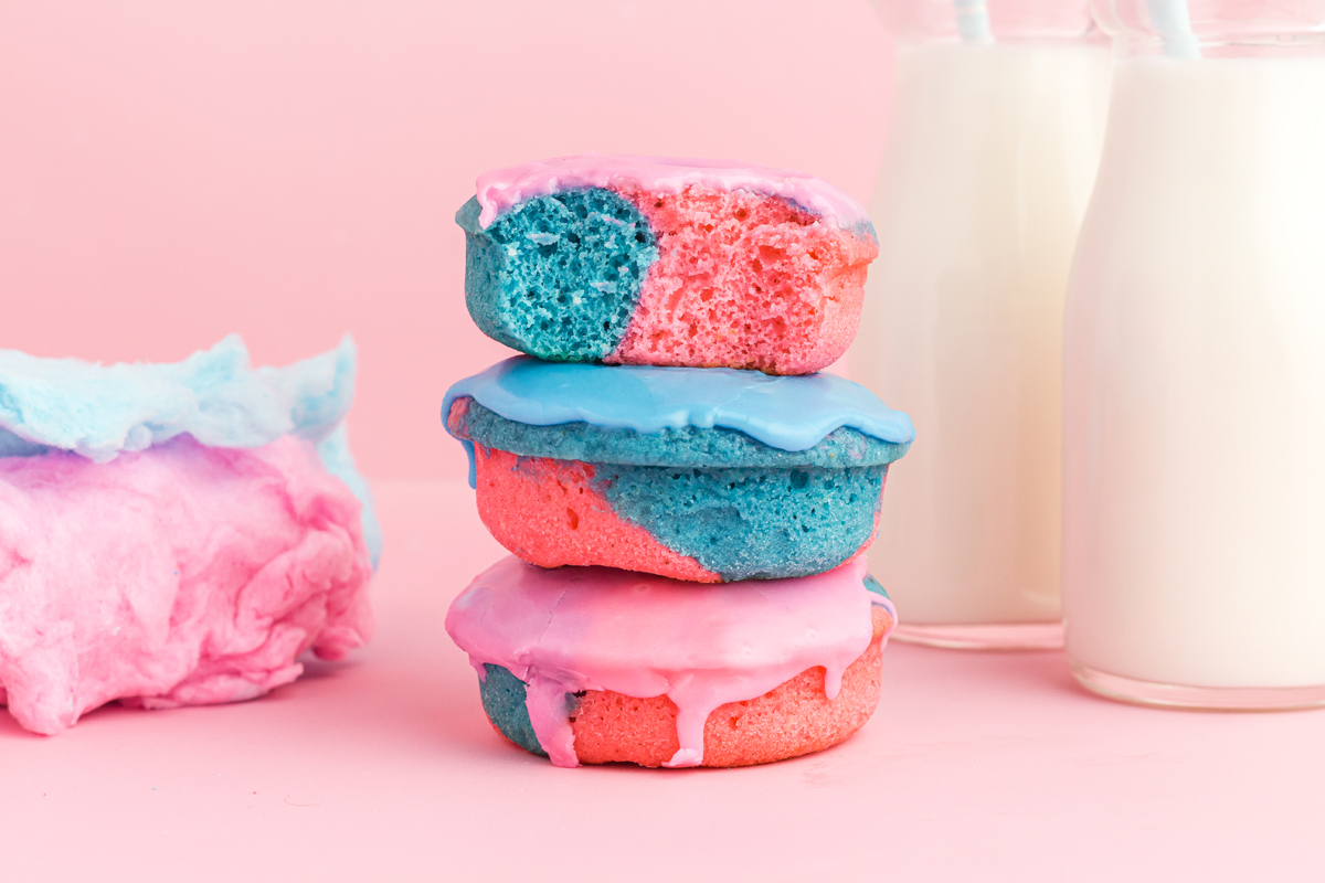 landscape photo stack of 3 with the top one cut in half. cotton candy blue and pink on the left peeking out and 2 milk jugs on the right. 